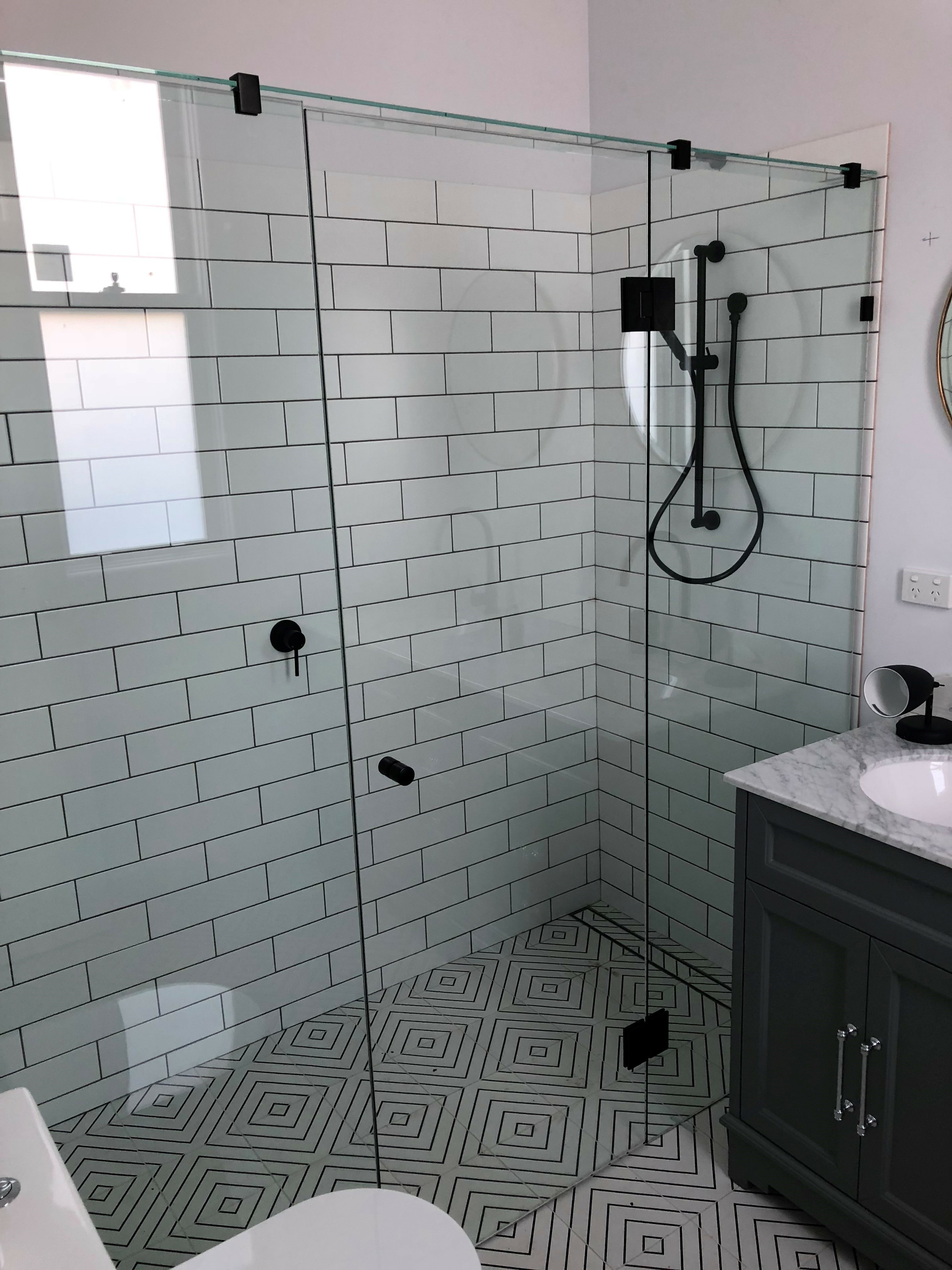 Shower installed by 30 Build Group black shower glass hardware
